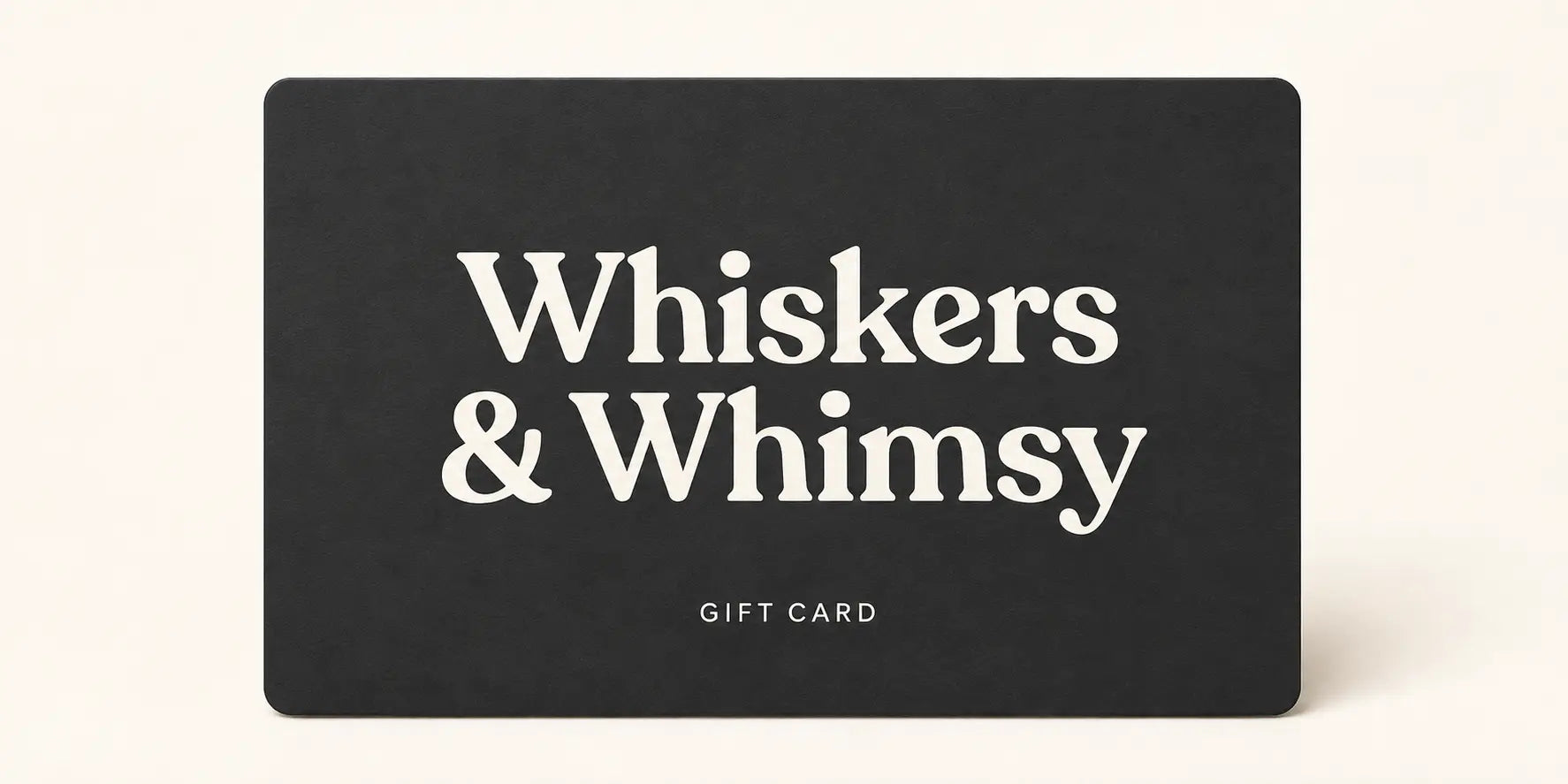 Charcoal Whiskers & Whimsy gift card with a warm ivory wordmark